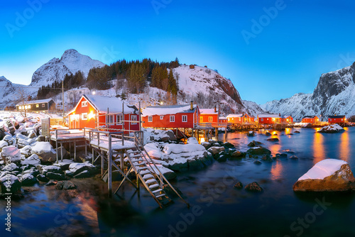 Fantastic evening seascape of Norwegian sea and cityscape of Nusfjord village.