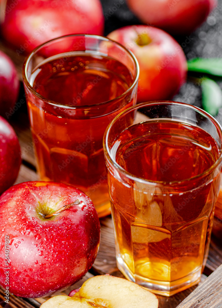 Apple juice on a wooden tray. Apple juice on a wooden tray.