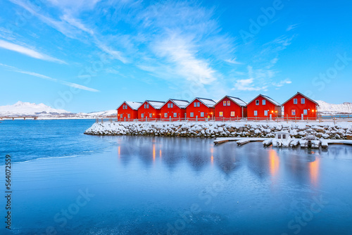 Gorgeous scenery wit traditional red wooden houses on the shore of Offersoystraumen fjord.