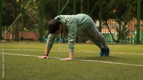 young man doing push ups
athlete training in the park
