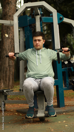 young man exercising in the park
athlete exercising on machine
