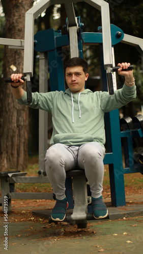 young man exercising in the park
athlete exercising on machine
