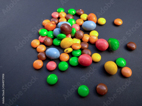 Sweetness rainbow coloured candy coated with chocolate inside