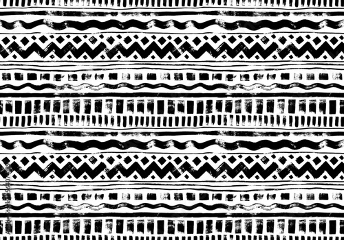 Hand drawn tribal and ethnic seamless pattern. Vector tribal design monochrome background with horizontal stripes, zig zag and wavy lines, dahses and squares. Aztec abstract geometric ornament.