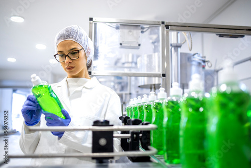 Female technologist controlling production of cleaning supplies for cleaning industry. Checking quality of detergent.
