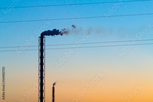 Shot of exhaust pipes of chemical plant over sky background