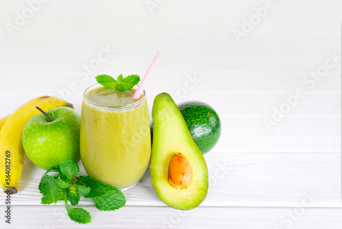 Avocado and Banana mix apple fresh cocktail smoothies fruit juice beverage healthy the taste yummy in glass drink episode good morning on white wooden background.
