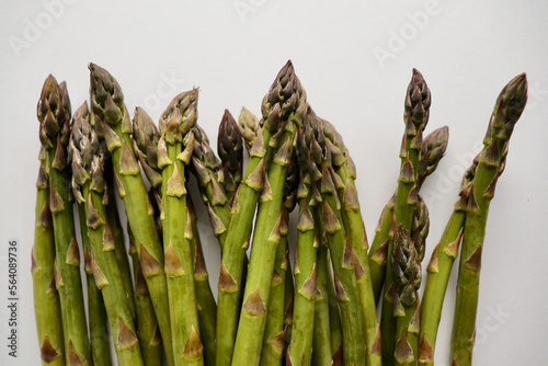bunch of fresh asparagus against neutral background with copy space