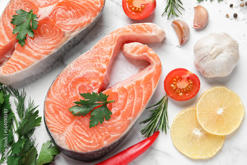 Fresh salmon and ingredients for marinade on white marble table, flat lay