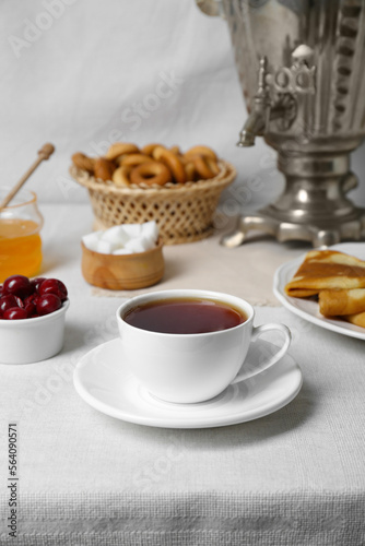 Aromatic tea  traditional Russian samovar and treats on table
