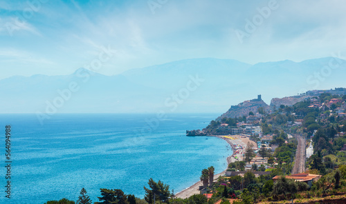 Azure Tyrrhenian sea bay and Rock of Capo Zafferano view from coastline highway road E90, Palermo region, Sicily, Italy. People are unrecognizable. photo