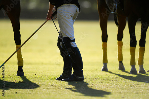 man is ready to get on the horse and start playing polo  photo