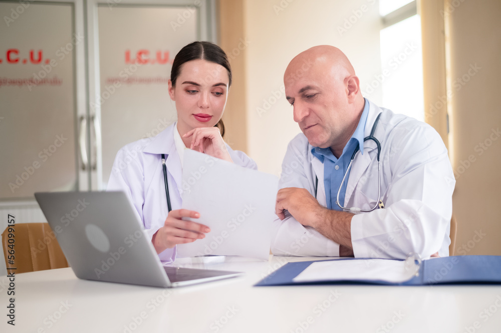 doctor talking with woman doctor at hospital meeting room doctor talking with woman doctor at hospital meeting room
