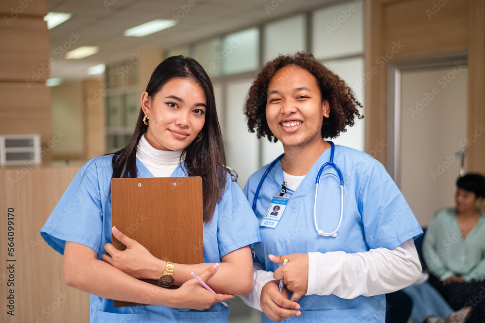 Nurse student Multi-ethnic group of happy nursing students talking medical university corridor.