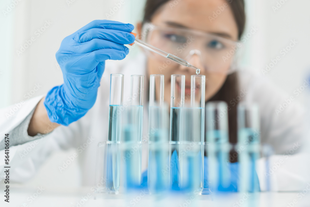 Medical development research laboratory, chemist or science scientist student hand in glove, drop water into pipette for test analysis liquid sample in clinic lab. Microbiology, analysing for medicine Medical development research laboratory, chemist or science scientist student hand in glove, drop water into pipette for test analysis liquid sample in clinic lab. Microbiology, analysing for medicine