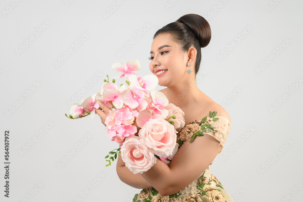 Young asian beautiful bride with orchid bouquet on white background Young asian beautiful bride with orchid bouquet on white background