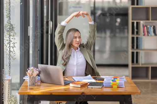 Bored Young business Asian woman sitting at her workplace at the office esk for a long time, Work mental health feel boring and Lazy, Freelance employees sleeping lying, Stress concept. photo