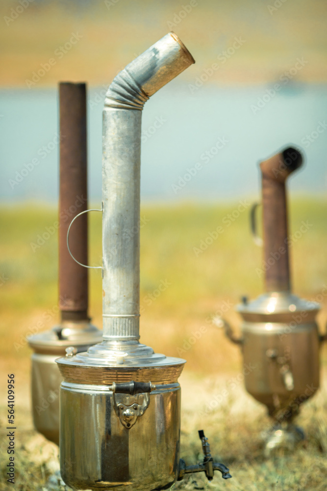 Boiling samovar in the steppe, Catering travel outdoor.
