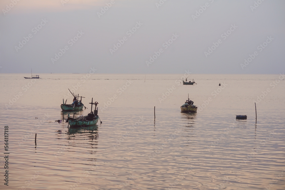 fishing boats sailing in the middle of the sea