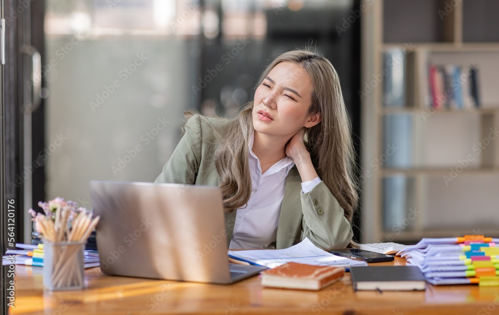 Asian women are stressed while working on laptop, Tired asian businesswoman with headache at office, feeling sick at work, copy space Asian women are stressed while working on laptop, Tired asian businesswoman with headache at office, feeling sick at work, copy space
