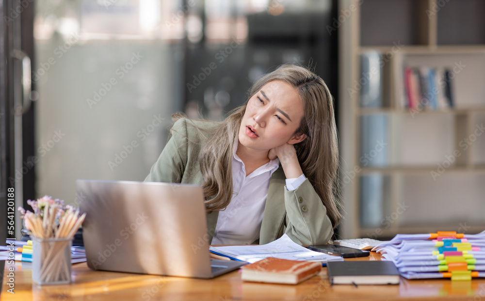 Asian women are stressed while working on laptop, Tired asian businesswoman with headache at office, feeling sick at work, copy space Asian women are stressed while working on laptop, Tired asian businesswoman with headache at office, feeling sick at work, copy space