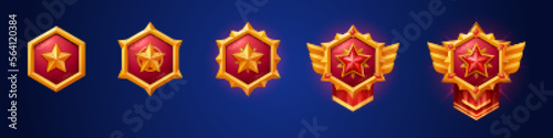 Cartoon set of gold game badges of different rank isolated on dark blue background. Vector illustration of red hexagon medals with star, golden metal textures. Collection of level awards