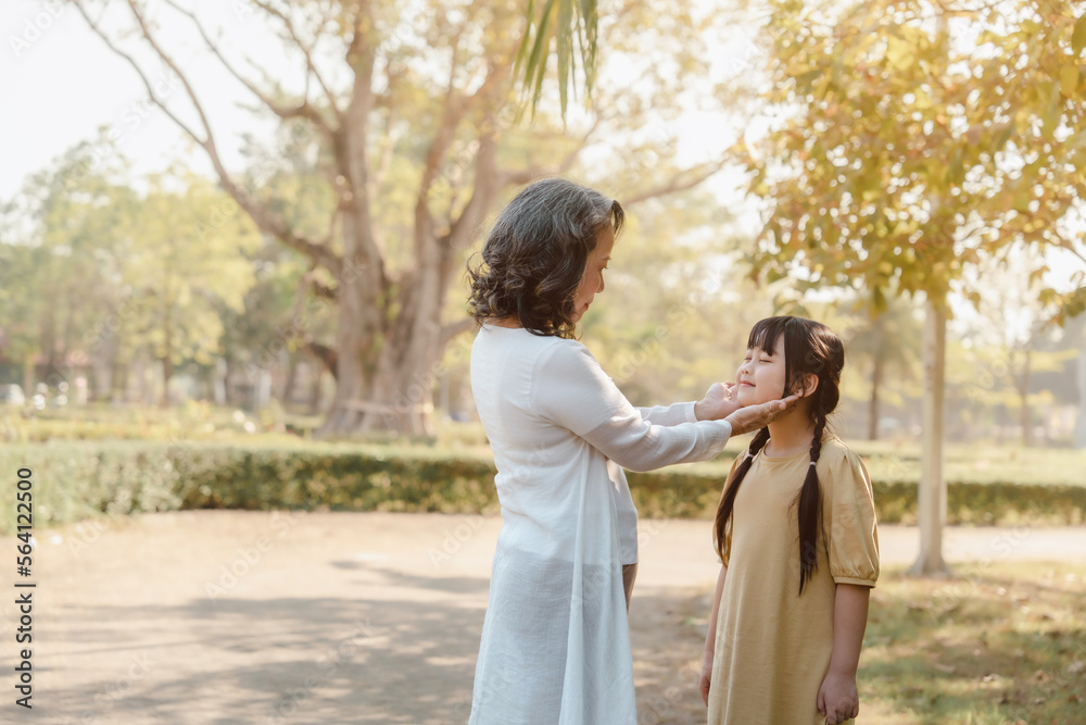 Naklejka premium Portrait of asia grandmother and grandchildren holiday vacation together in the park in the summer in Southeast Asia Pacific.