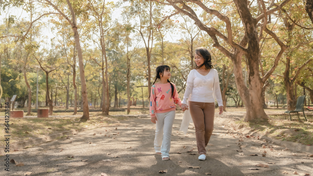 Portrait of asia grandmother and grandchildren holiday vacation together in the park in the summer in Southeast Asia Pacific. Walking