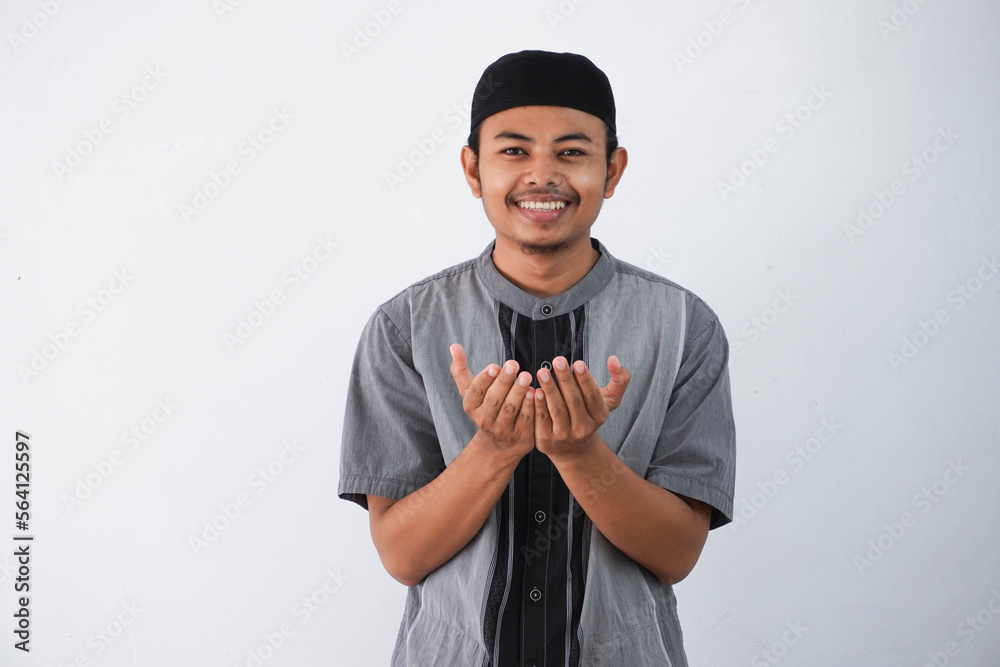Religious young asian muslim man with open eyes praying, holding palms face up, whispering pray, isolated on white background. Religion islam, believing concept Religious young asian muslim man with open eyes praying, holding palms face up, whispering pray, isolated on white background. Religion islam, believing concept