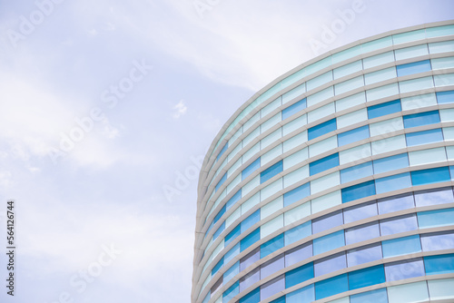 facade of a modern building covered in reflective plates and glass. Modern glass facade office building.hub for media, entertainment and IT industry. geometric pattern.copy space