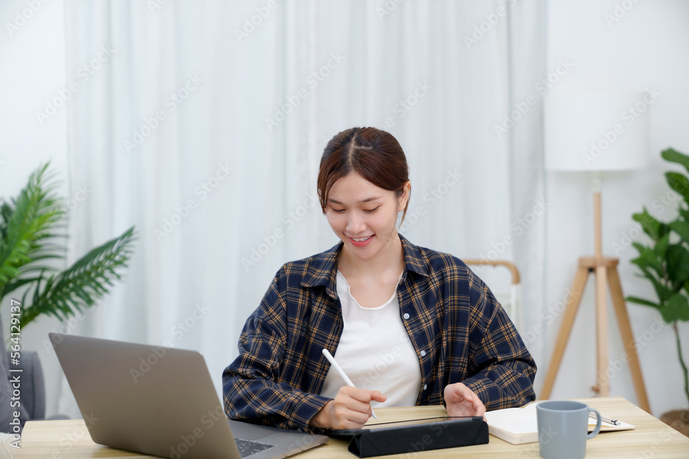 Young asian girl using laptop reading e-book for online learning. Young asian girl using laptop reading e-book for online learning.