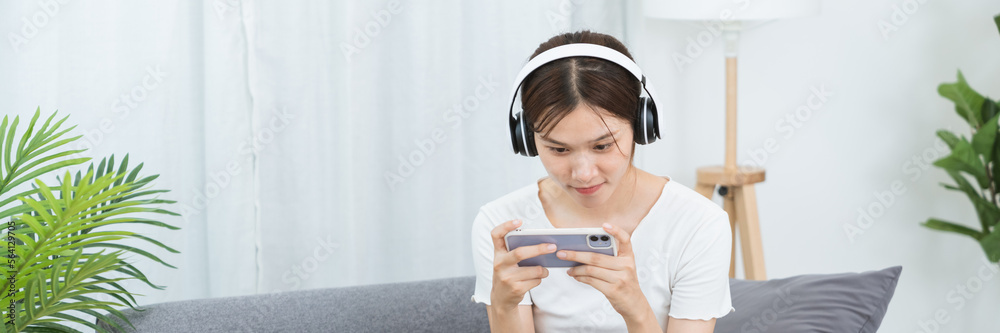Happy asian woman using mobile phone Pro Streamer Winning video game on smartphone. Happy asian woman using mobile phone Pro Streamer Winning video game on smartphone.
