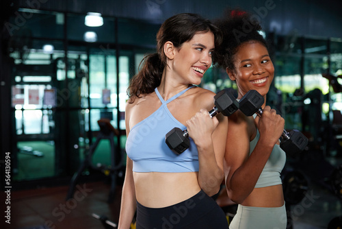 young athletic women smiling and lifting dumbbell in the gym © offsuperphoto