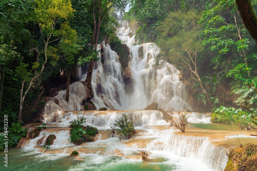 Kuang Si waterfalls close to the popular town of Luang Prabang, Laos. A three level waterfall with jade green pools surrounded with lush green tropical jungle. A popular tourist attraction. No people.