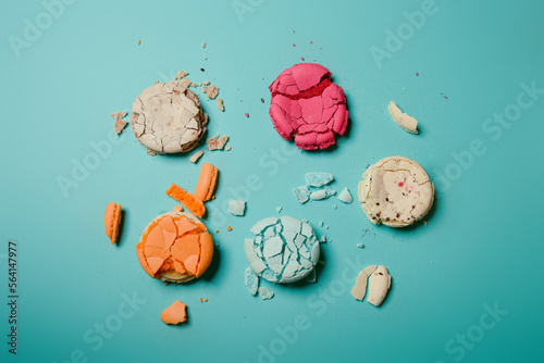 Close-up of macaroons of different colors in blue background. Culinary and tsuking concept. Tasti tsolurful matzaroons. Pastel color. food deconstruction.. photo