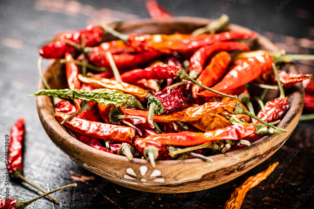 Wooden plate with dried chili peppers. 