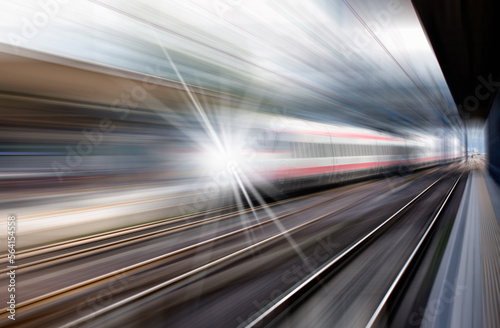 High speed train runs on rail tracks - The train is going too fast as a result the air pressure is causing too much heat at the front © muratart