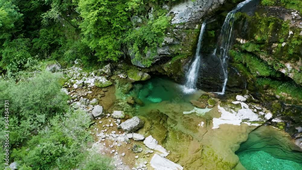 Descending Tilting Up Shot Of Virje Waterfall falling Into Charming Pool Of Green Emerges, Caught between Lush Growth And Moss-covered Rocks. Beautiful Emerald Pool in Middle of Beautiful Green Forest Descending Tilting Up Shot Of Virje Waterfall falling Into Charming Pool Of Green Emerges, Caught between Lush Growth And Moss-covered Rocks. Beautiful Emerald Pool in Middle of Beautiful Green Forest