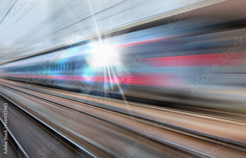 High speed train runs on rail tracks - The train is going too fast as a result the air pressure is causing too much heat at the front © muratart