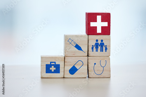 Healthcare, insurance and wooden blocks in studio on an empty gray background for safety or security. Abstract, medicine and health with block toys in a hospital or clinic for medical care