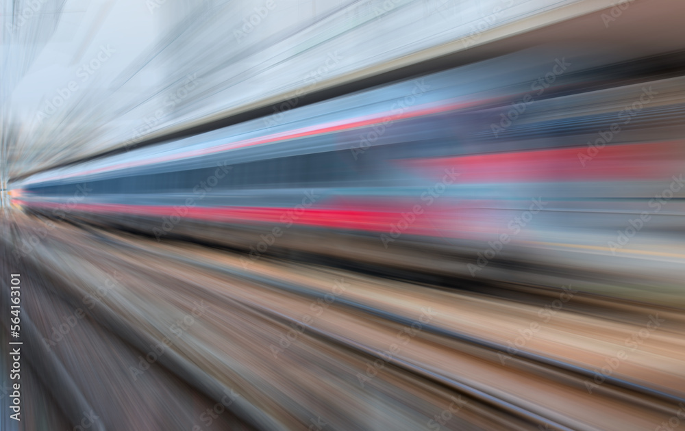 Blue high speed train runs on rail tracks - The train is going too fast as a result the air pressure is causing too much heat at the front Blue high speed train runs on rail tracks - The train is going too fast as a result the air pressure is causing too much heat at the front