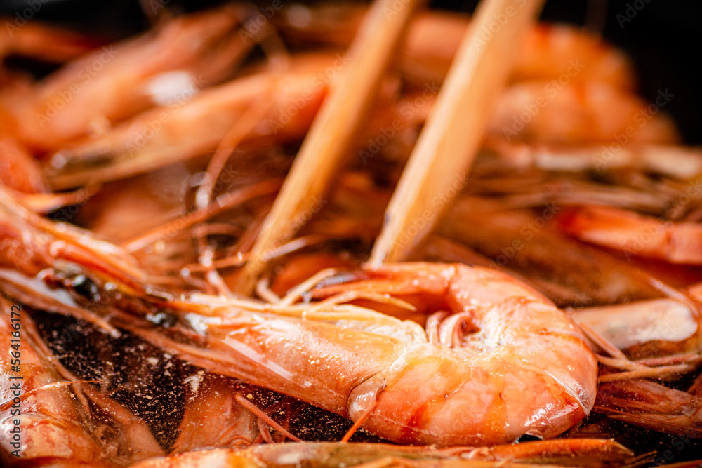 The shrimp are cooked in a pot of water. The shrimp are cooked in a pot of water.
