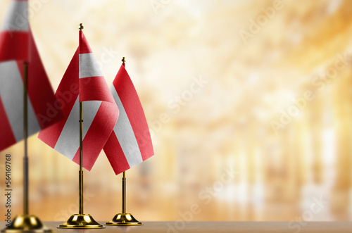Small flags of the Austria on an abstract blurry background