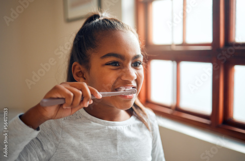 Girl brushing teeth  toothbrush for hygiene and clean mouth  fresh breath for oral care and dental health. Black child cleaning with toothpaste in bathroom  wellness at family home and healthy gums