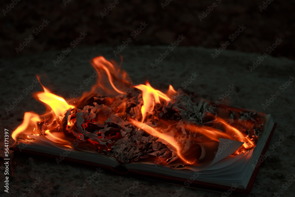 A burning book on the ground