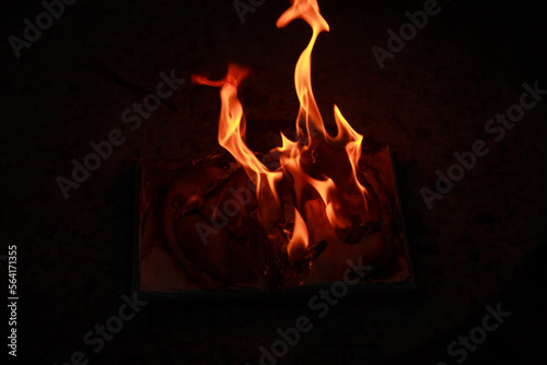 A burning book on the ground photo