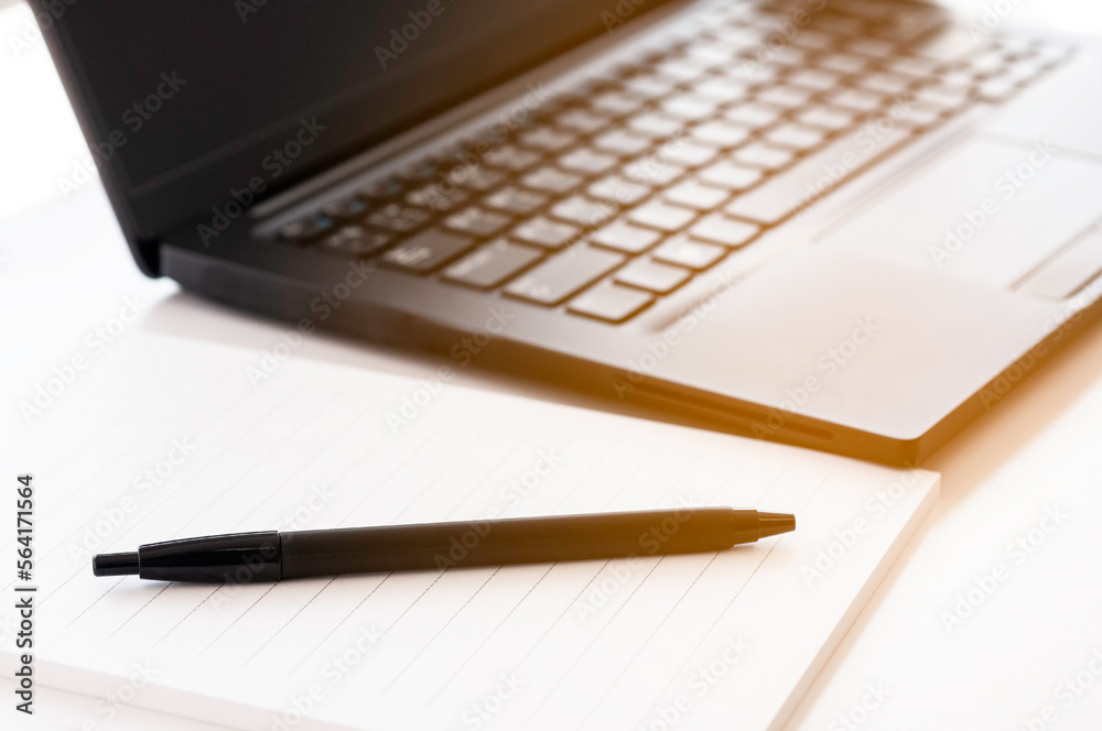 Single black laptop and note pad and pen ready for meeting and run project, business conception brain strom and get idea for customer. Single black laptop and note pad and pen ready for meeting and run project, business conception brain strom and get idea for customer.