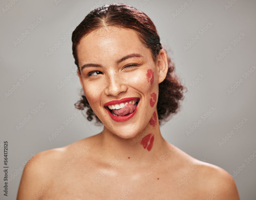Beauty, face and woman lipstick and wink with kiss print on skin, flirt and sexy, tongue out isolated on studio background. Red, lips and smile with skincare, makeup mockup, fun and cosmetic care Beauty, face and woman lipstick and wink with kiss print on skin, flirt and sexy, tongue out isolated on studio background. Red, lips and smile with skincare, makeup mockup, fun and cosmetic care