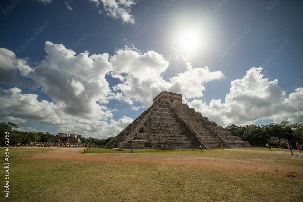 chichen itza pyramid with clouds and sun - youkatamn