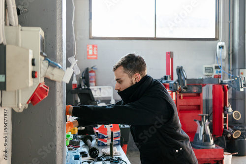 Car mechanic working in a garage